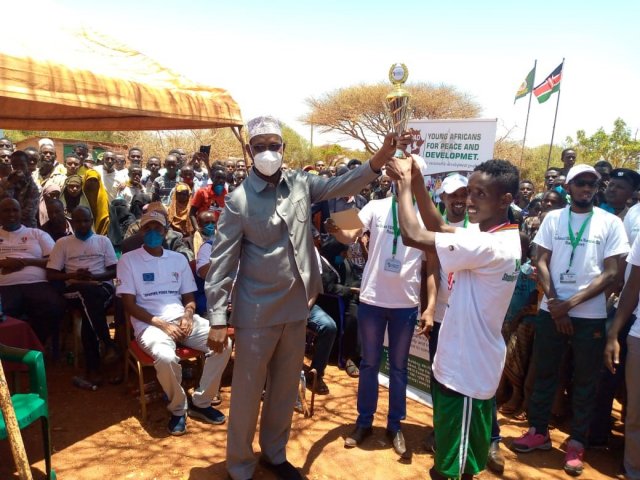 Commissioner Hon. Abdulaziz Farah awards a trophy to the winner of Mandera Peace Marathon held during the International Day of Peace celebrations in Mandera County on 21st September, 2020